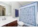 Stylish bathroom with a sink, toilet, and shower featuring modern fixtures and a patterned shower curtain at 8654 Arailia Dr, Plainfield, IN 46168