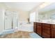 Bright bathroom with soaking tub, walk-in shower, and a vanity with dark wood cabinets at 8654 Arailia Dr, Plainfield, IN 46168