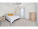 Cozy bedroom with neutral walls and a ceiling fan complemented by wood furniture and natural lighting at 8654 Arailia Dr, Plainfield, IN 46168