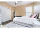 Bright bedroom featuring a queen bed, modern ceiling fan, and a sliding door closet for convenient storage at 8654 Arailia Dr, Plainfield, IN 46168