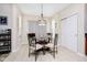 Bright dining area features a modern light fixture, a glass top table, and neutral decor at 8654 Arailia Dr, Plainfield, IN 46168