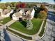Aerial view of a well-maintained home with mature trees and a spacious front yard at 8654 Arailia Dr, Plainfield, IN 46168