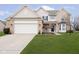 Charming two-story home with a well-manicured lawn, attached two car garage and beautiful brick and vinyl siding at 8654 Arailia Dr, Plainfield, IN 46168