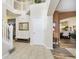 Spacious foyer featuring tile flooring, an open staircase, and views into the dining room and living room at 8654 Arailia Dr, Plainfield, IN 46168