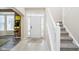 Welcoming foyer features tile flooring, a staircase with white railing, and a view of the front door at 8654 Arailia Dr, Plainfield, IN 46168