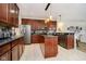 Spacious kitchen with stainless steel appliances, a central island, and dark wood cabinetry at 8654 Arailia Dr, Plainfield, IN 46168