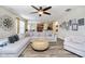 Large sectional sofa in a living room with hardwood flooring, and lots of natural light at 8654 Arailia Dr, Plainfield, IN 46168