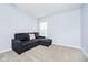 Contemporary living room featuring a plush couch, soft carpeting, and a bright window for natural light at 8654 Arailia Dr, Plainfield, IN 46168
