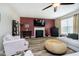 Spacious living room boasts hardwood floors, a ceiling fan, and a cozy fireplace at 8654 Arailia Dr, Plainfield, IN 46168