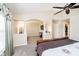 Main bedroom with sitting area featuring arched doorways, and neutral carpet at 8654 Arailia Dr, Plainfield, IN 46168
