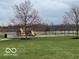 Community playground features a swing set, slide and play structure at 8654 Arailia Dr, Plainfield, IN 46168