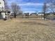 Backyard with view of pond and surrounding neighborhood homes on a sunny day at 9107 Tenor Way, Indianapolis, IN 46231