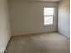Carpeted room with white walls and natural light from the window at 9107 Tenor Way, Indianapolis, IN 46231