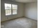 Carpeted room with large window that provides natural light at 9107 Tenor Way, Indianapolis, IN 46231