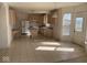 Open kitchen with tile flooring, island, and adjacent access to the backyard at 9107 Tenor Way, Indianapolis, IN 46231