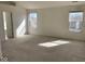 Spacious main bedroom featuring carpet flooring, light-colored walls, and natural light from two windows at 9107 Tenor Way, Indianapolis, IN 46231