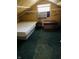 Attic bedroom includes inspirational wall decor, a window air conditioner, a bed and ottoman at 945 N Ewing St, Indianapolis, IN 46201