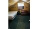 Attic bedroom includes inspirational wall decor, a window air conditioner, a bed and ottoman at 945 N Ewing St, Indianapolis, IN 46201