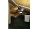 Attic bedroom with carpet, window AC, vaulted ceiling, and unique architectural design at 945 N Ewing St, Indianapolis, IN 46201