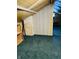 Attic space with wood paneled walls, green carpeting and storage at 945 N Ewing St, Indianapolis, IN 46201