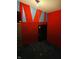 Basement space with red and blue walls and a black door at 945 N Ewing St, Indianapolis, IN 46201