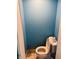 Compact toilet and toilet paper holder in a small, painted bathroom at 945 N Ewing St, Indianapolis, IN 46201