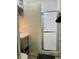 Bathroom with tiled walls, a gray vanity, and a glass shower stall at 945 N Ewing St, Indianapolis, IN 46201