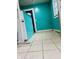 Bathroom with ceramic tile flooring, bright teal walls and white bead board at 945 N Ewing St, Indianapolis, IN 46201