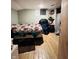 Bedroom with wood flooring, a patterned bedspread, shelves, and a view into a closet space at 945 N Ewing St, Indianapolis, IN 46201