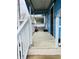 View of the front porch with tiled floor and white railing at 945 N Ewing St, Indianapolis, IN 46201