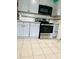 Renovated kitchen with sleek black microwave, stainless steel oven and ample storage at 945 N Ewing St, Indianapolis, IN 46201