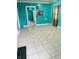 Turquoise living room highlighting patterned tile flooring and views into the next room at 945 N Ewing St, Indianapolis, IN 46201