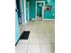 Turquoise living room showcasing patterned tile flooring and multiple doorways at 945 N Ewing St, Indianapolis, IN 46201