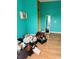 Spacious room with laminate floors, and vibrant walls, showcasing room for customization and personalization at 945 N Ewing St, Indianapolis, IN 46201