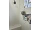 All-white tiled shower with a showerhead, a niche, and a glass block window at 945 N Ewing St, Indianapolis, IN 46201