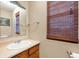 Cozy bathroom features a vanity, mirror, and window with blinds, providing a functional and comfortable space at 9698 W Lantern Ln, Pendleton, IN 46064