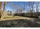 Fenced backyard with grass and a fire pit area on a sunny day at 1130 E Bradbury Ave, Indianapolis, IN 46203