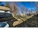 A fenced backyard with grass and a fire pit area on a sunny day at 1130 E Bradbury Ave, Indianapolis, IN 46203