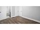 Neutral bedroom features light gray walls and wood-look floors, with a view of the adjacent bathroom through an open door at 1130 E Bradbury Ave, Indianapolis, IN 46203