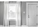 Bright interior view featuring a white door and window with white curtains at 1130 E Bradbury Ave, Indianapolis, IN 46203