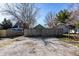 The property features a gravel parking area with a wooden fence in the background at 1130 E Bradbury Ave, Indianapolis, IN 46203