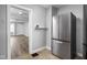 View of kitchen leading to living room, with updated stainless steel refrigerator at 1130 E Bradbury Ave, Indianapolis, IN 46203
