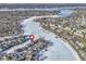 Aerial view of lakefront community on a frozen lake, pinpointing a property with a red location marker at 11338 Bayhill Way, Indianapolis, IN 46236