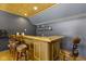 Finished basement bar featuring wood detail, bar stools, and built-in shelving for ample storage at 11338 Bayhill Way, Indianapolis, IN 46236