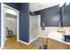 Bathroom featuring a tiled shower, wood-look floors, a gray color scheme, and a walk-in closet at 11338 Bayhill Way, Indianapolis, IN 46236
