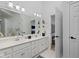 Bright primary bath featuring double sinks, vanity and large mirror at 11338 Bayhill Way, Indianapolis, IN 46236