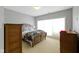 Bright bedroom with a large window, a bed with patterned bedding, and two dressers at 11338 Bayhill Way, Indianapolis, IN 46236