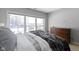 Bedroom with a view of the water through large windows, a dresser, and a bed with patterned bedding at 11338 Bayhill Way, Indianapolis, IN 46236