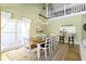Elegant dining room with large table, modern lighting, and access to a second-story balcony at 11338 Bayhill Way, Indianapolis, IN 46236