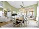 Open-concept dining and living space featuring a large dining table, stylish lighting, and a comfortable seating area at 11338 Bayhill Way, Indianapolis, IN 46236